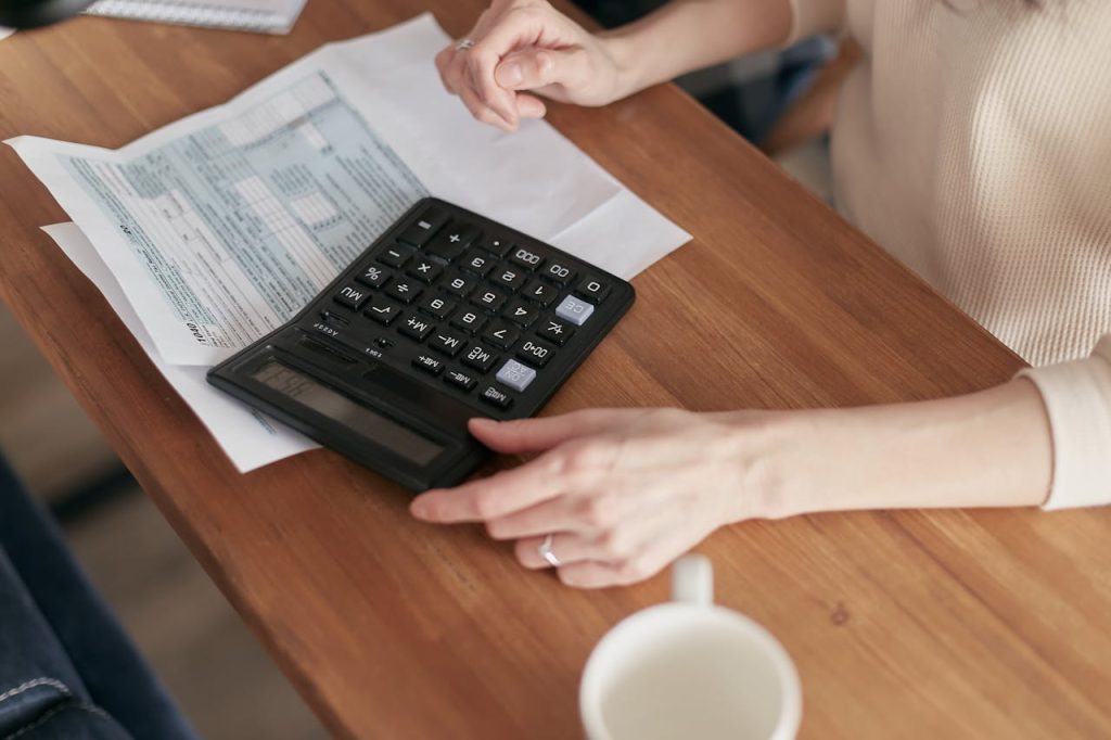 A real estate agent using a calculator to price the property