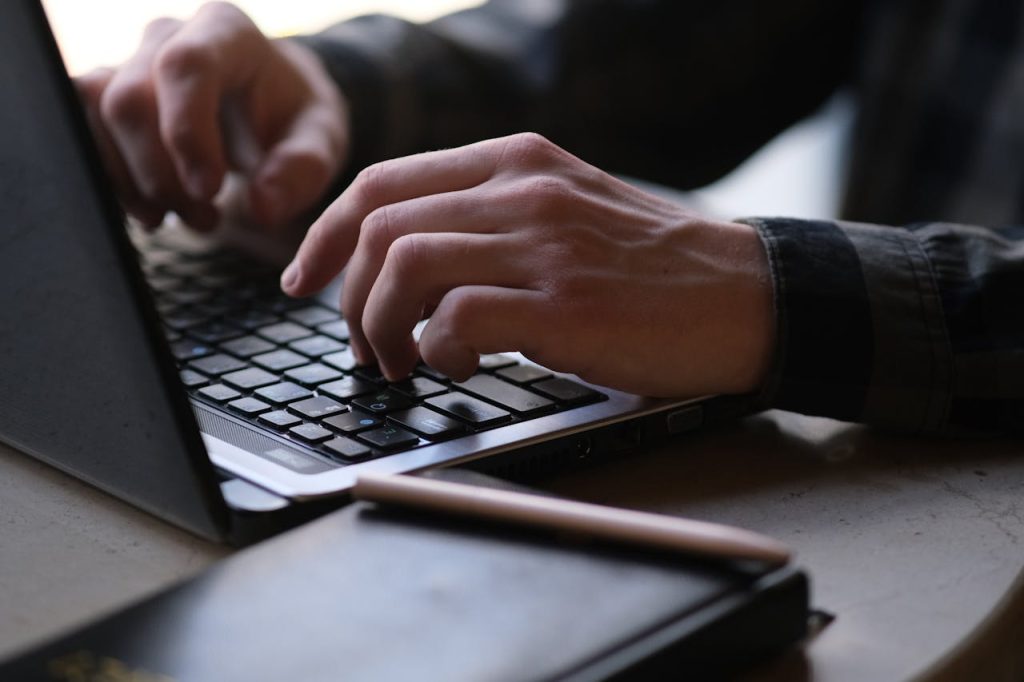 Client typing a testimonial on laptop.