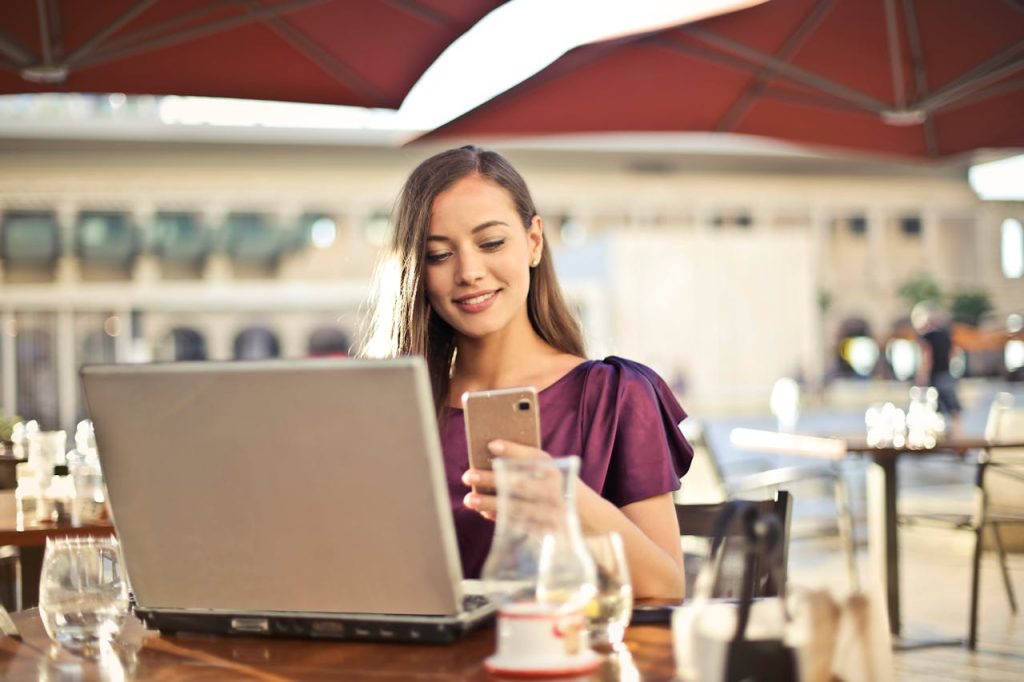 Homebuyer or seller seeing testimonials for real estate agents on her phone.