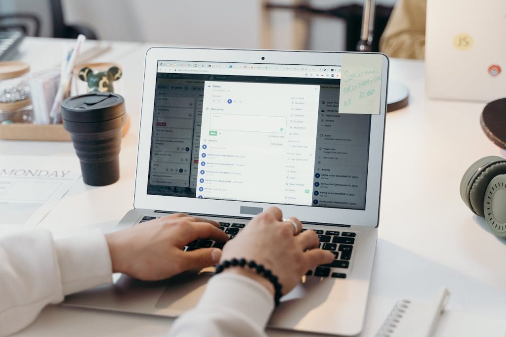 Person working on a laptop with a project management tool open.